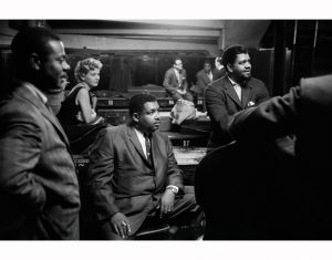 Armando Peraza, Helen Merrill, "Cannonball" Adderley, Al McKibbon, with Toots Thielmans and Oscar Peterson reflected in the mirror, backstage at Orchestra Hall, Chicago, 1957.